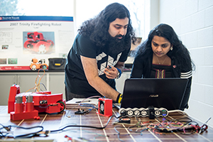 Two people using a laptop